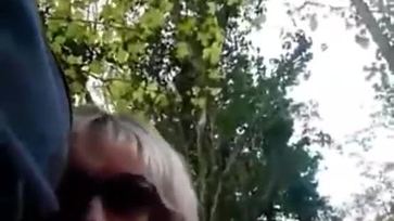 Mature sucks a guy while walking in the forest